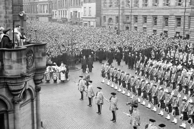 Thousands of people swarm around the mercat cross in Edinburgh to hear the proclamation of accession of Queen Elizabeth II in 1952. Picture: TSPL