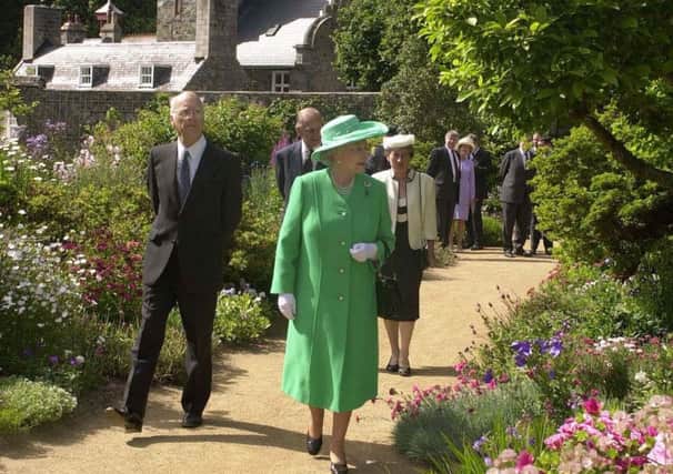 Michael Beaumont shows Queen Elizabeth II around the Seigneurie gardens on the island of Sark, in 2001. Picture: Fiona Hanson