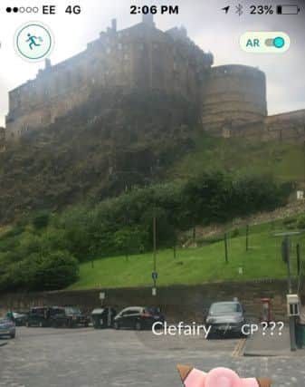 Pokemon Go game in Edinburgh's Grassmarket looking up to Edinburgh Castle. Picture: SWNS