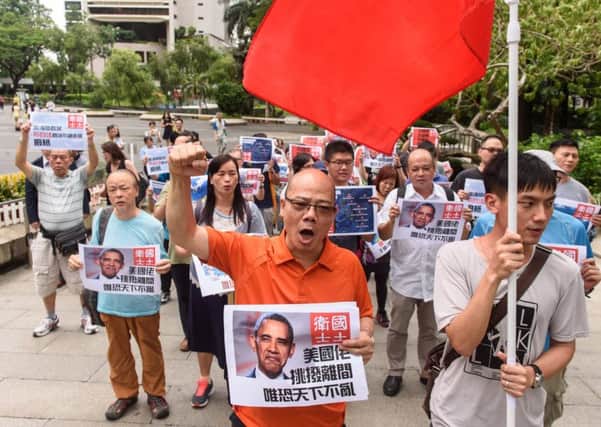 Pro-China protesters shout slogans as they walk towards Hong Kongs US Consulate to protest against the Hague court ruling. Picture: Getty