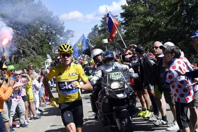 Britain's Chris Froome, wearing the overall leader's yellow jersey, runs after he crashed at the end of stage 12 of the Tour de France on Mont Ventoux. Picture: Stephane Mantey/AP