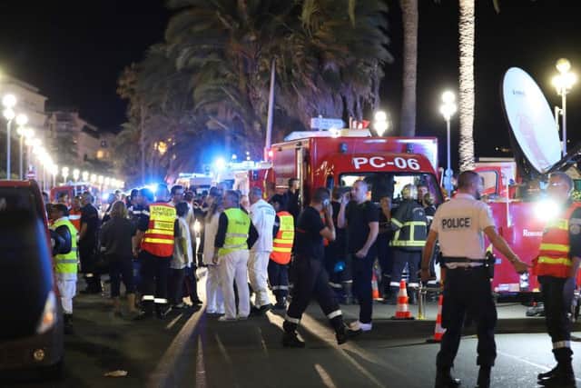 Police officers, firefighters and rescue workers are seen at the scene of the attack. Picture: AFP/Getty Images