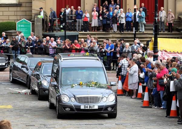 Mourners pay their respects as the funeral cortege carrying the coffin of murdered MP Jo Cox passes through Batley Market Square in Batley, north-west England. Picture: Getty Images
