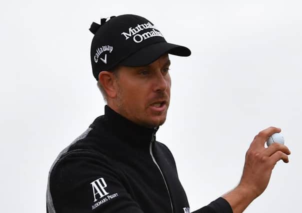 Henrik Stenson, pictured, and Soren Kjeldsen are well placed for the weekend after posting impressive scores in difficult weather conditions at Troon yesterday. Picture: AFP/Getty