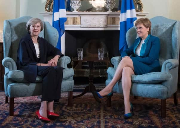 Theresa May and Nicola Sturgeon pose for the cameras in Bute House. Picture: James Glossop/Getty