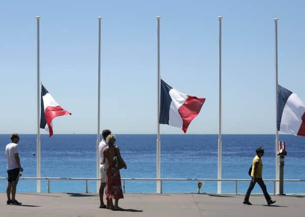 The Promenade des Anglais yesterday with flags at half mast near the scene of the attack on Thursday. Picture: Laurent Cipriani/AP