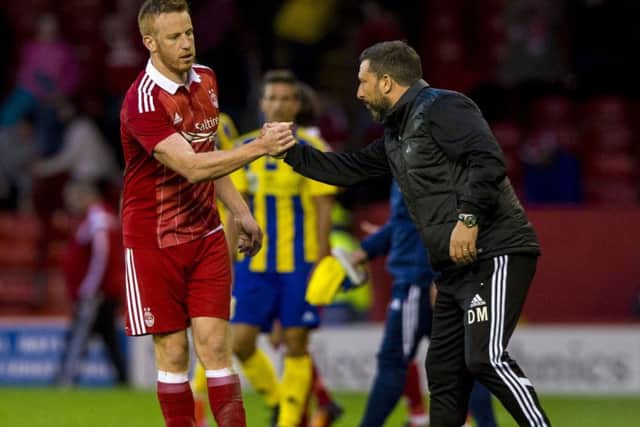 Aberdeen manager Derek McInnes (right) shakes hands with Adam Rooney. Picture: SNS