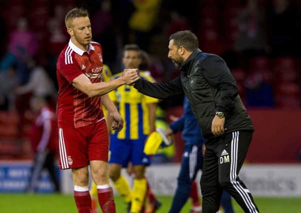 Aberdeen manager Derek McInnes (right) shakes hands with Adam Rooney. Picture: SNS