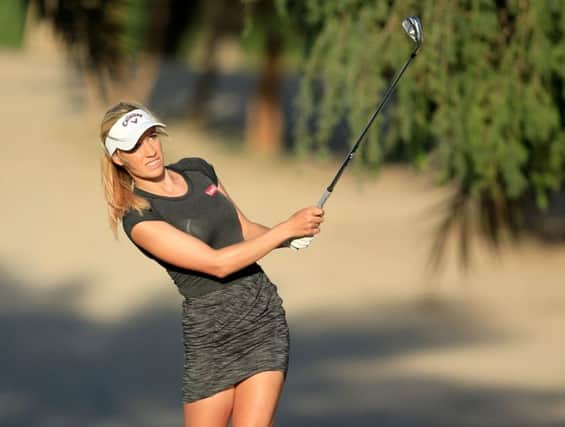 Paige Spiranac plays an approach shot in Dubai. Picture: David Cannon/Getty Images