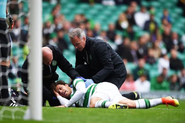 Celtic defender Erik Sviatchenko receives treatment after sustaining a head injury. Photograph: Rob Casey/SNS