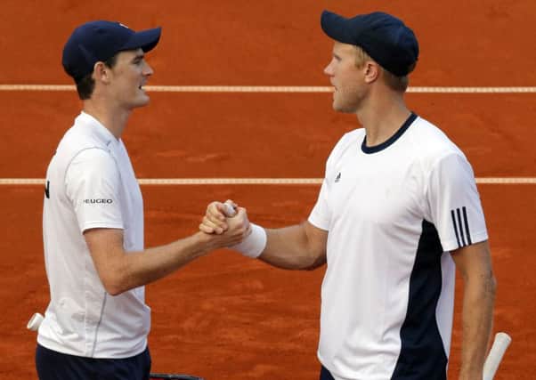 Britain's Jamie Murray and Dom Inglot celebrate their win over Serbia's Filip Krainovic and Nenad Zimonjic.  Picture: Pedja Milosavljevic/AFP/Getty Images