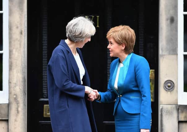Theresa May meets Nicola Sturgeon outside Bute House. Picture: Getty Images