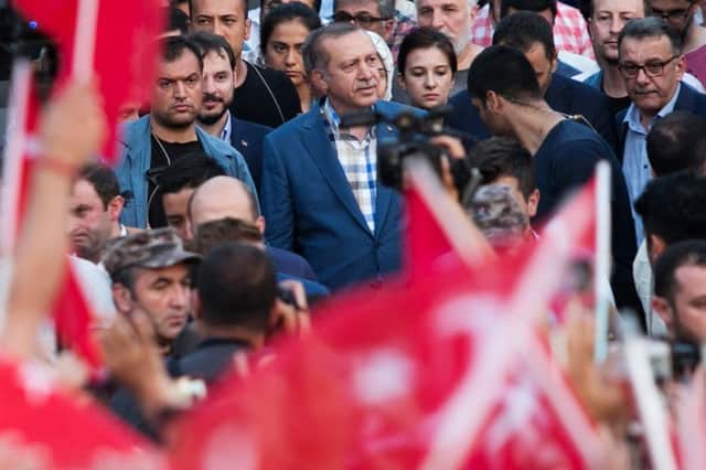 President Recep Tayyip Erdogan (checked shirt) arrives to speak at a rally near his house in Istanbul. Picture: AFP/Getty