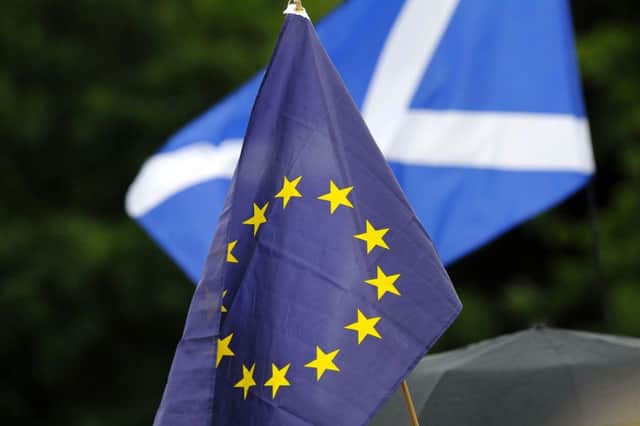 European Union and Scottish flags held aloft by pro-EU campaigners outside the Scottish Parliament last month. Picture: AFP/Getty