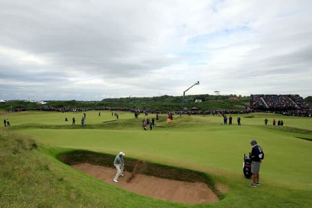 Bill Haas extricates his ball from sand at the Postage Stamp yesterday on his way to a bogey 4. The previous day he had chipped in from the Coffin bunker for a birdie 2. Picture: PA