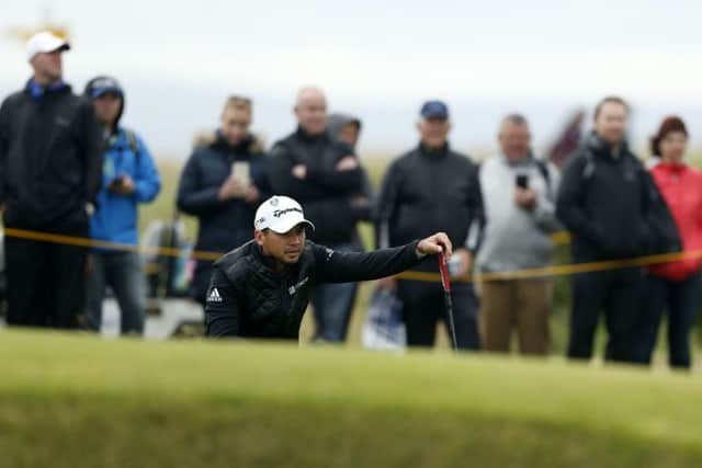 Jason Day lines up a putt at the third hole yesterday. Picture: PA