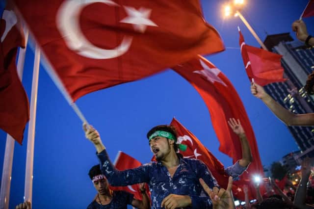 Demonstrators wave Turkish flags at Taksim square in Istanbul. Picture: AFP/Getty