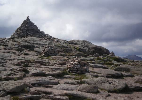 A straight line of cairns leads to the large summit cairn and weather station beyond. Picture: Nick Drainey