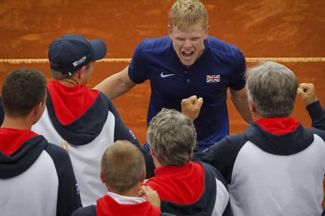 Kyle Edmund celebrates victory with members of the GB team after his singles win put them into the Davis Cup semi-finals. Picture: Getty