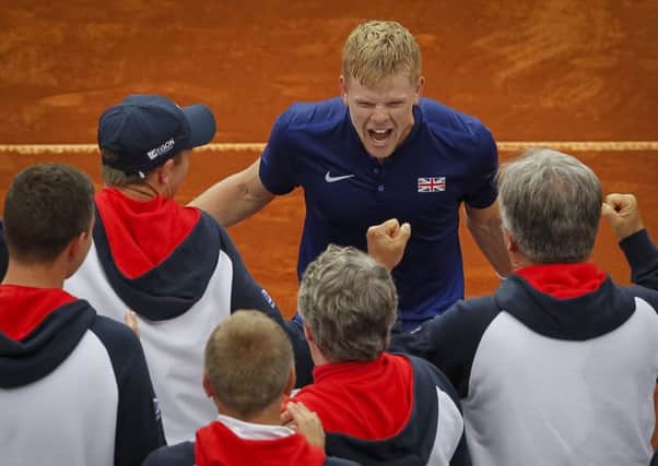 Kyle Edmund celebrates victory with members of the GB team after his singles win put them into the Davis Cup semi-finals. Picture: Getty