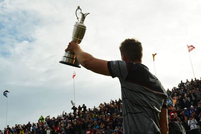 Henrik Stenson holds the Claret Jug aloft after his epic victory at Royal Troon on Sunday. Picture: AFP/Getty