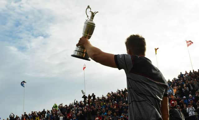 Henrik Stenson holds the Claret Jug aloft after his epic victory at Royal Troon on Sunday. Picture: AFP/Getty