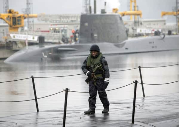 A member of the armed services walks on the deck of Vanguard-class submarine HMS Vigilant. Picture: PA