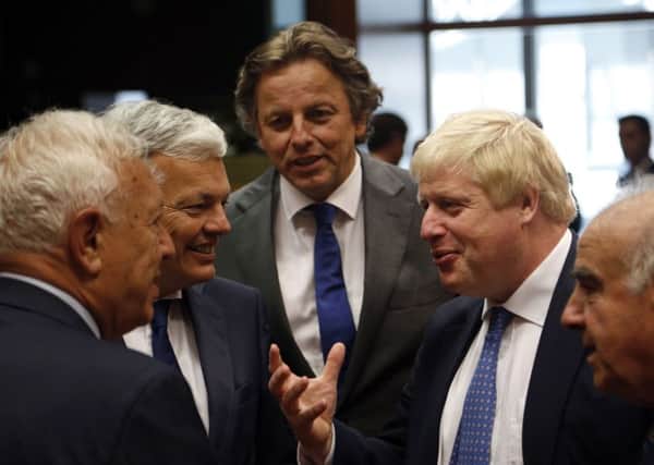 Foreign Secretary Boris Johnson, second from right, speaks with other ministers before Monday's meeting. Picture: AP
