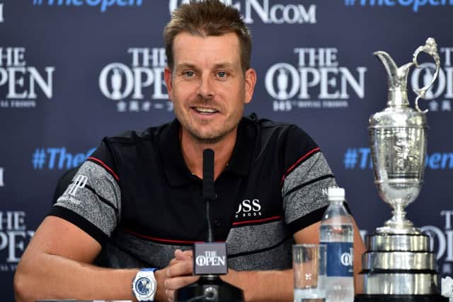 Sweden's Henrik Stenson answers questions from members of the media as he sits with the Claret Jug. Picture: AFP/Getty