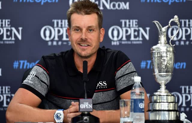 Sweden's Henrik Stenson answers questions from members of the media as he sits with the Claret Jug. Picture: AFP/Getty