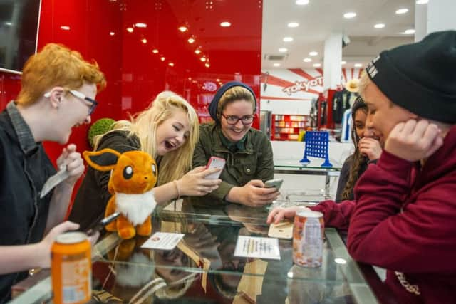 PokÃ©mon Go fans enjoy the new craze at Tokyo Toys shop in Glasgow. Picture: John Devlin