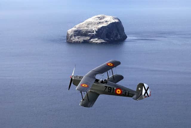 Gavin Hunter takes the Bucker Jungmann for a practice flight over the Bass Rock. Picture: PA