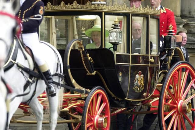 The Queen and Duke of Edinburgh in the Scottish State Coach leaving Holyrood Palace. Picture: PA Photo/Sandy Young