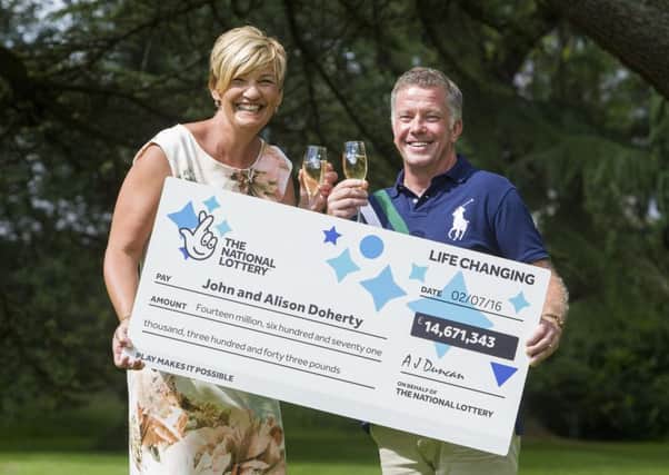 Alison and John Doherty, from Eldersley, Renfrewshire, celebrate their winnings. Picture: SWNS