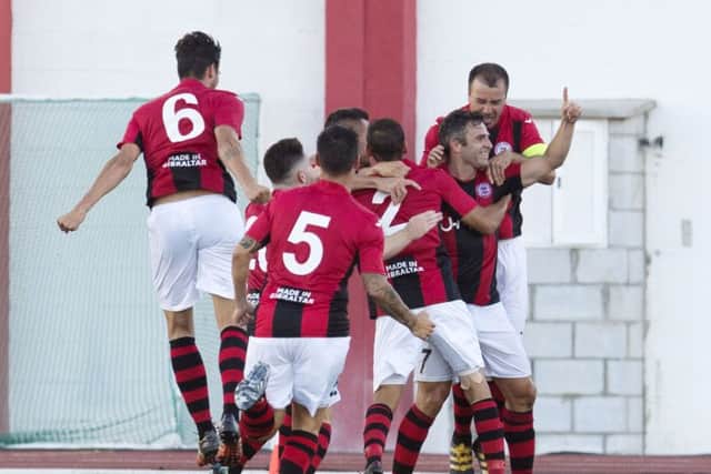 The Lincoln players surround Lee Casciaro (second from right) after the striker's first-leg goal. Picture: SNS