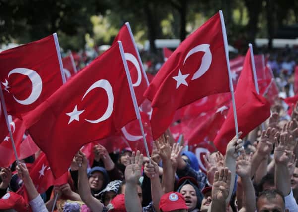 Pro-government wave Turkish flags as they protest against the attempted coup, in Istanbul, Tuesday, July 19, 2016. Picture: PA