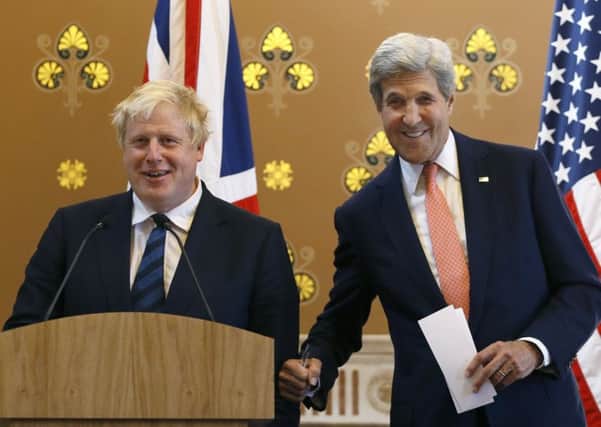 Foreign Secretary Boris Johnson, left, and US secretary of state John Kerry share a joke Picture: Kirsty Wigglesworth/PA Wire