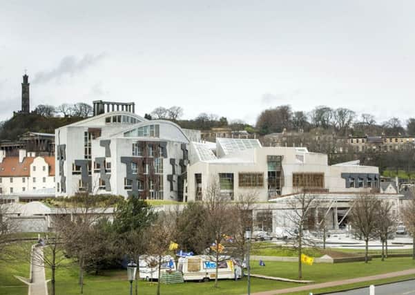 The Scottish Parliament, with the pro-independence Indy Camp settlement in the foreground. An SNP MP has admitted that an independent Scotland would face five years of painful budget cuts. Picture: PA