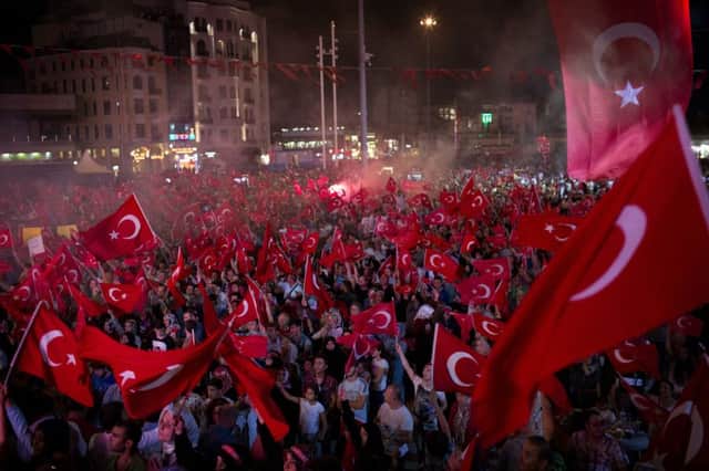 Government supporters wave Turkish flags during a protest in Taksim Square, Istanbul, on July 19. Picture: AP Photo/Emilio Morenatti