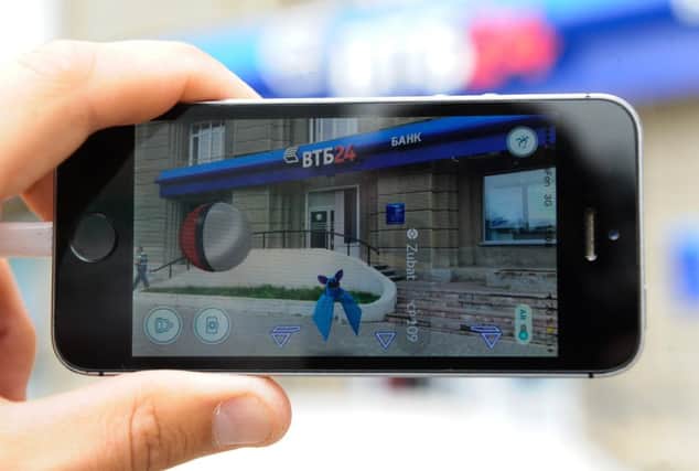 A gamer plays Pokemon Go on a smartphone. Picture: Getty Images