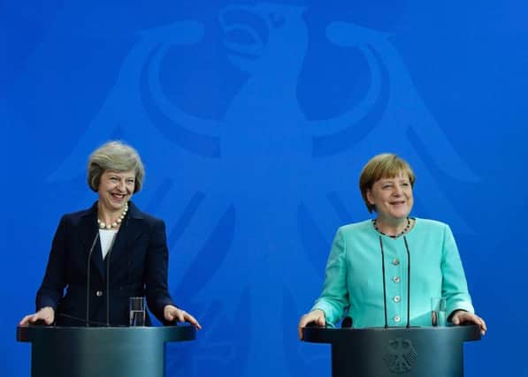 German Chancellor Angela Merkel welcomes Prime Minister Theresa May as she arrives at the chancellery in Berlin. Picture: AFP/Getty Images