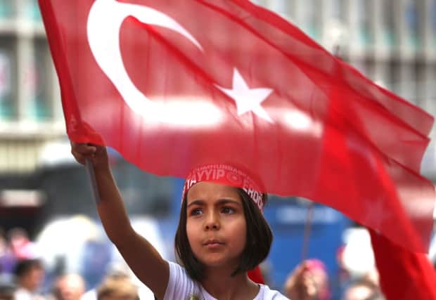 A Turkish girl wearing a headband bearing the name of Turkish president Recep Tayyip Erdogan. Picture: AP