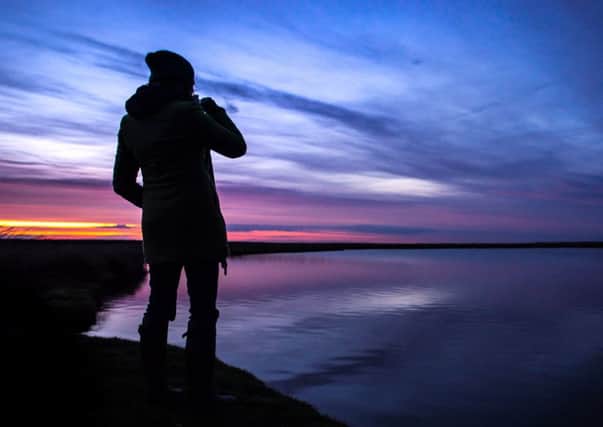 Wind Resistance 
performer Karine Polwart watches the sunset at the lochan. Picture: Contributed