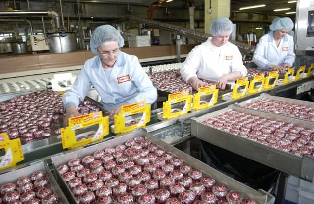Workers pack teacakes at the Tunnocks factory at Uddingston, Lanarkshire.
Picture: Robert Perry