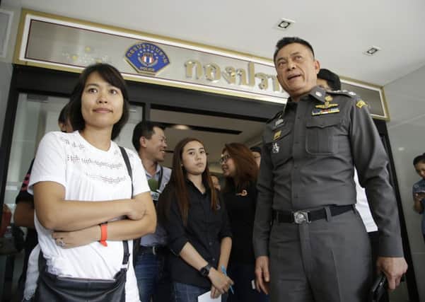 Police Lt. Gen. Thitiraj Nhongharnpitak stands with Noppawan "Ploy" Bunluesilp. Picture: AP