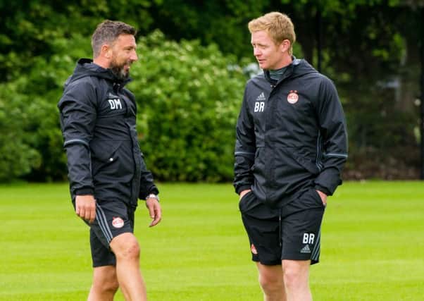 Barry Robson, right, has found his new coaching role under Derek McInnes testing. Picture: SNS