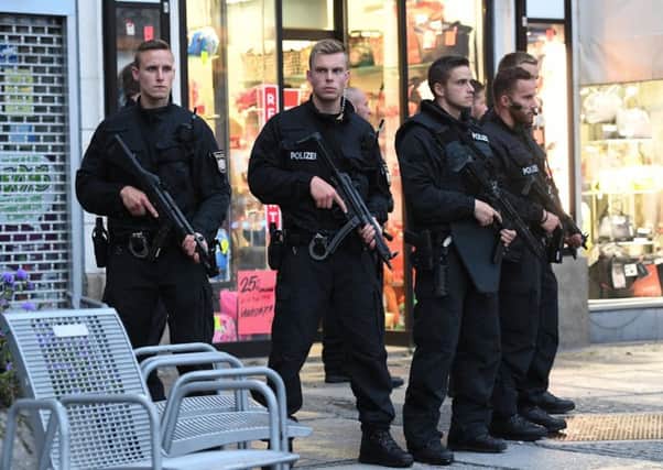 Police officers secure the Stachus hotel after a shooting in Munich, southern Germany. Picture: Sven Hoppe/dpa via AP