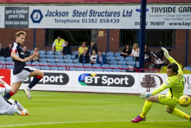 Dundee forward Greg Stewart slides the ball beyond Mark Brown to complete his hat-trick. Pic: Paul Devlin/SNS
