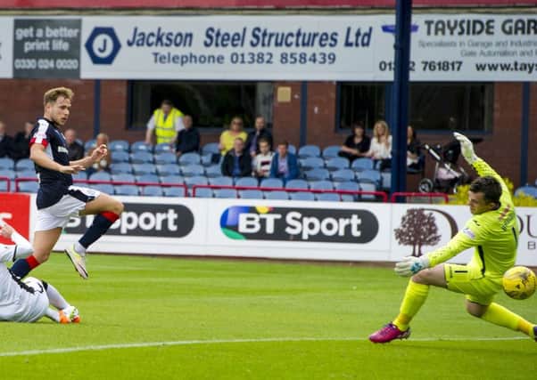 Dundee forward Greg Stewart slides the ball beyond Mark Brown to complete his hat-trick. Pic: Paul Devlin/SNS