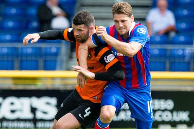 Mark Durnan, left, and Iain Vigurs battle for possession. Picture: Ross Parker/SNS